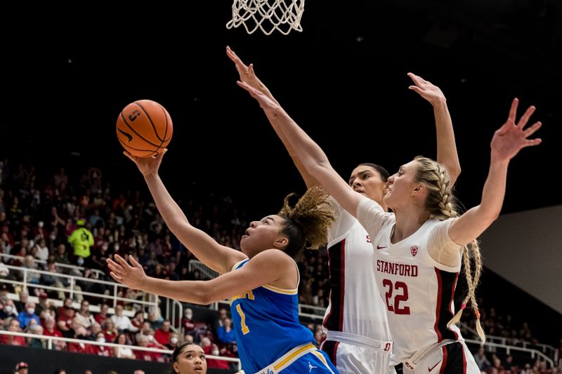 Feb 20, 2023; Stanford, California, USA;  Stanford Cardinal forward Cameron Brink (22) and center Lauren Betts (51) defend UCLA Bruins guard Kiki Rice (1) during the second half at Maples Pavilion. Mandatory Credit: John Hefti-USA TODAY Sports