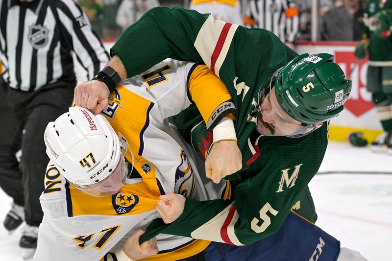 Jan 25, 2024; Saint Paul, Minnesota, USA; Nashville Predators forward Michael McCarron (47) and Minnesota Wild defenseman Jacob Middleton (5) fight during the second period at Xcel Energy Center. Mandatory Credit: Nick Wosika-USA TODAY Sports