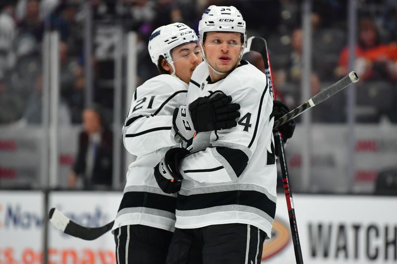 Nov 24, 2023; Anaheim, California, USA; Los Angeles Kings right wing Arthur Kaliyev (34) celebrates his goal scored against the Anaheim Ducks with defenseman Jordan Spence (21) during the first period at Honda Center. Mandatory Credit: Gary A. Vasquez-USA TODAY Sports