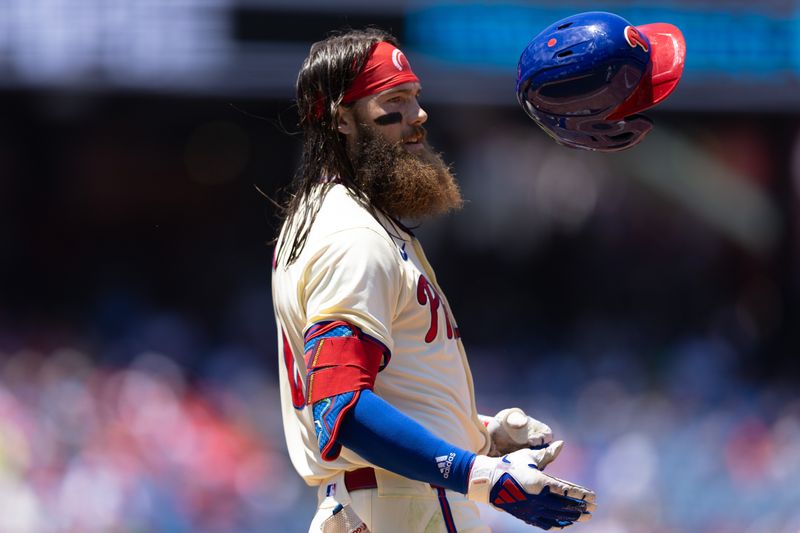 Jun 19, 2024; Philadelphia, Pennsylvania, USA; Philadelphia Phillies outfielder Brandon Marsh (16) flips his helmet after hitting for an out to end the first inning against the San Diego Padres at Citizens Bank Park. Mandatory Credit: Bill Streicher-USA TODAY Sports