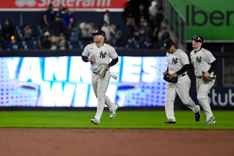 Sep 29, 2024; Bronx, New York, USA; New York Yankees outfielder Jasson Domínguez (89), New York Yankees outfielder Trent Grisham (12) and New York Yankees outfielder Alex Verdugo (24) react after winning against the Pittsburgh Pirates at Yankee Stadium. Mandatory Credit: John Jones-Imagn Images