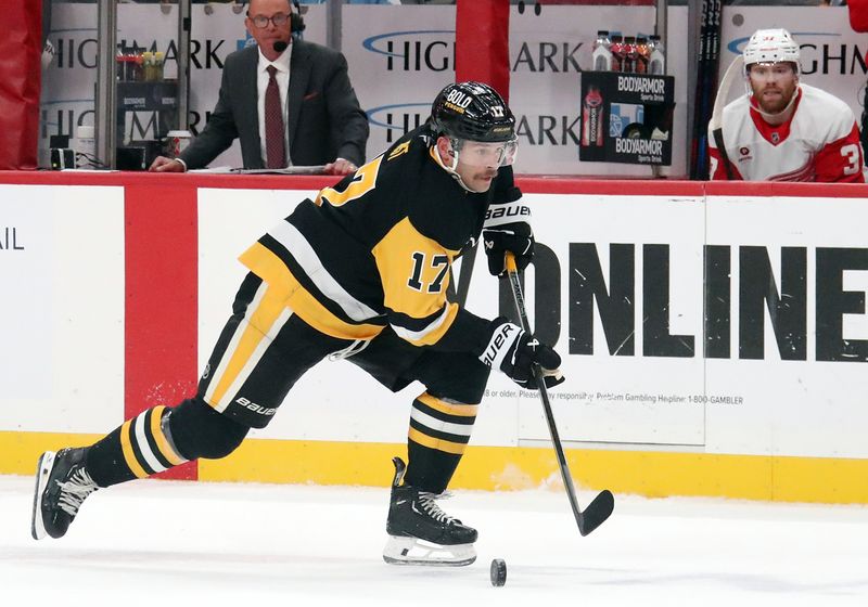 Nov 13, 2024; Pittsburgh, Pennsylvania, USA;  Pittsburgh Penguins right wing Bryan Rust (17) skates up ice with the puck against the Detroit Red Wings during the first period at PPG Paints Arena. Mandatory Credit: Charles LeClaire-Imagn Images