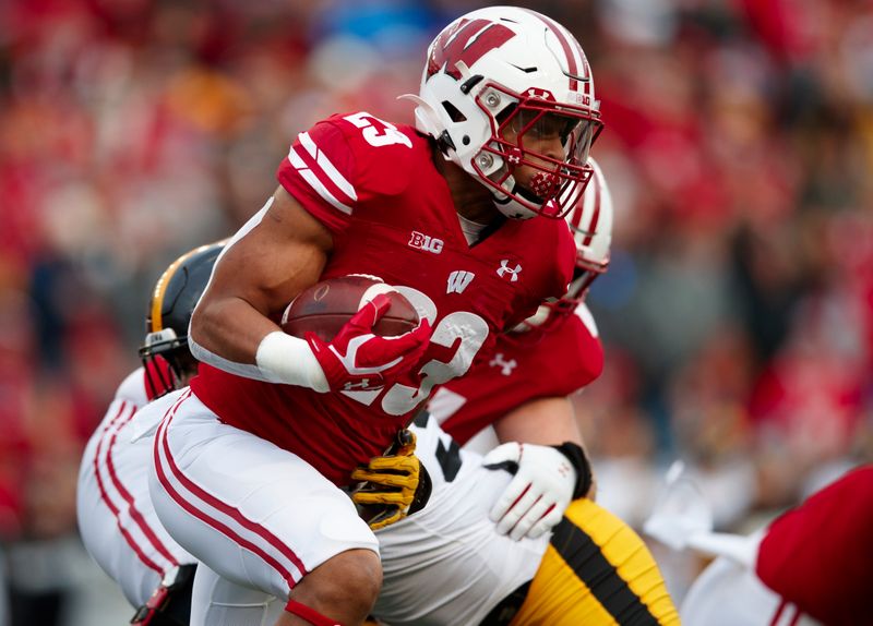 Nov 9, 2019; Madison, WI, USA; Wisconsin Badgers running back Jonathan Taylor (23) rushes with the football during the first quarter against the Iowa Hawkeyes at Camp Randall Stadium. Mandatory Credit: Jeff Hanisch-USA TODAY Sports