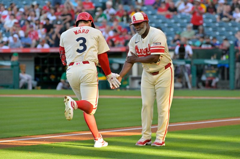 Jun 24, 2024; Anaheim, California, USA;  Los Angeles Angels left fielder Taylor Ward (3) is congratulated by third base coach Eric Young Sr. (85) after hitting a two-run home run in the first inning against the Oakland Athletics at Angel Stadium. Mandatory Credit: Jayne Kamin-Oncea-USA TODAY Sports
