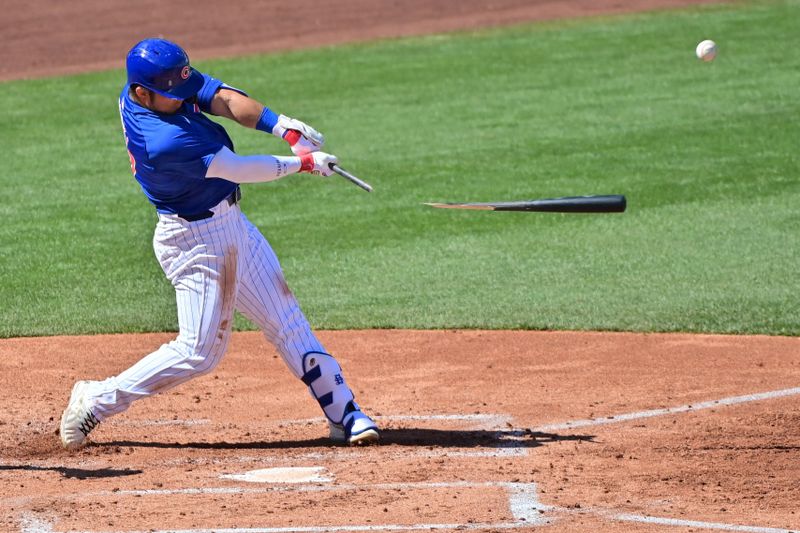 Mar 8, 2024; Mesa, Arizona, USA;  Chicago Cubs right fielder Seiya Suzuki (27) break his bat hitting an RBI single in the second inning against the Seattle Mariners  during a spring training game at Sloan Park. Mandatory Credit: Matt Kartozian-USA TODAY Sports