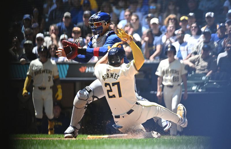 May 30, 2024; Milwaukee, Wisconsin, USA; Milwaukee Brewers shortstop Willy Adames (27) slides in safely to home plate against Chicago Cubs catcher Miguel Amaya (9) in the second inning at American Family Field. Mandatory Credit: Michael McLoone-USA TODAY Sports