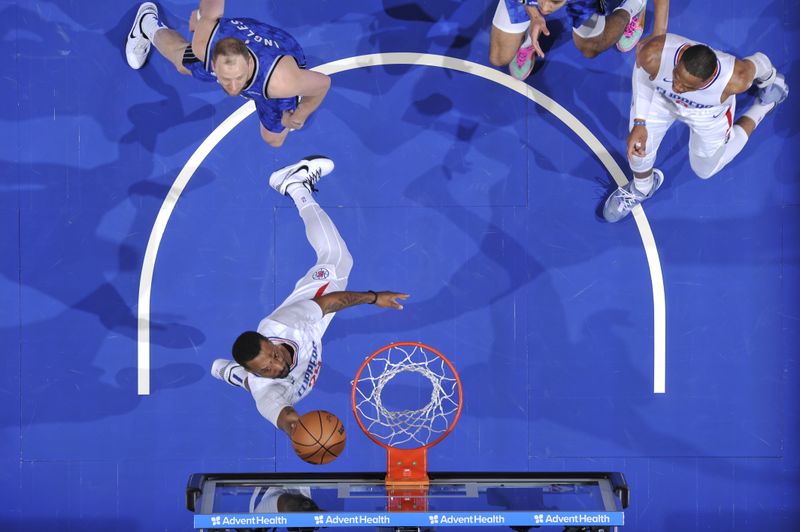 ORLANDO, FL - MARCH 29:Norman Powell #24 of the LA Clippers drives to the basket during the game against the Orlando Magic  on March 29, 2024 at the Kia Center in Orlando, Florida. NOTE TO USER: User expressly acknowledges and agrees that, by downloading and or using this photograph, User is consenting to the terms and conditions of the Getty Images License Agreement. Mandatory Copyright Notice: Copyright 2024 NBAE (Photo by Fernando Medina/NBAE via Getty Images)