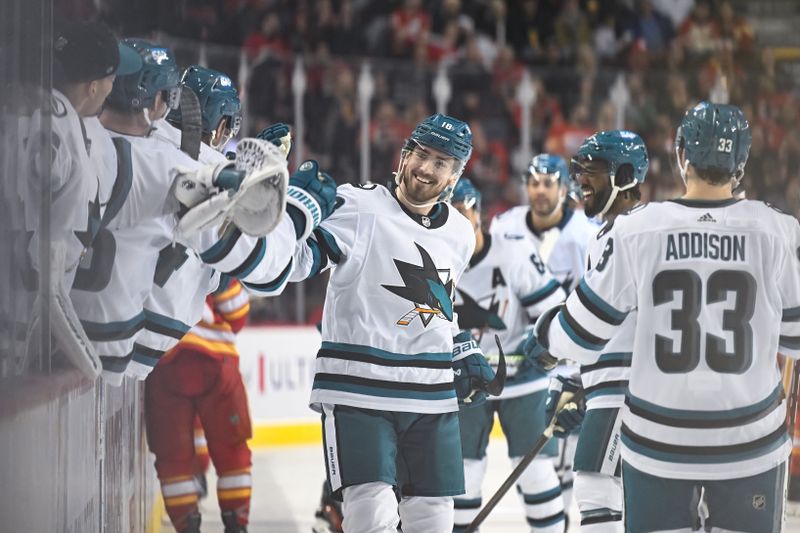 Feb 15, 2024; Calgary, Alberta, CAN; San Jose Sharks right wing Filip Zadina (18) celebrates a goal against the Calgary Flames with teammates during the third period at Scotiabank Saddledome. Mandatory Credit: Brett Holmes-USA TODAY Sports