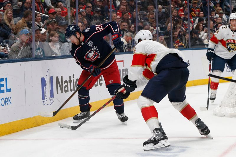 Mar 5, 2026; Columbus, Ohio, USA; Columbus Blue Jackets center Mathieu Olivier (24) carries the puck as Florida Panthers defenseman Aaron Ekblad (5) defends during the second period at Nationwide Arena. Mandatory Credit: Russell LaBounty-Imagn Images