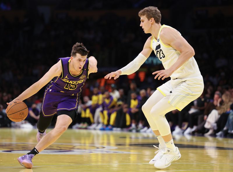 LOS ANGELES, CALIFORNIA - NOVEMBER 19: Austin Reaves #15 of the Los Angeles Lakers drives against Lauri Markkanen #23 of the Utah Jazz during the first quarter of the Emirates NBA Cup at Crypto.com Arena on November 19, 2024 in Los Angeles, California. NOTE TO USER: User expressly acknowledges and agrees that, by downloading and or using this photograph, User is consenting to the terms and conditions of the Getty Images License Agreement.  (Photo by Harry How/Getty Images)