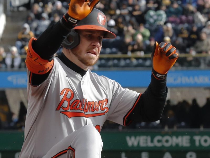 Apr 5, 2024; Pittsburgh, Pennsylvania, USA;  Baltimore Orioles designated hitter Ryan O'Hearn (32) slides into third base for a triple against the Pittsburgh Pirates during the fourth inning at PNC Park. Mandatory Credit: Charles LeClaire-USA TODAY Sports