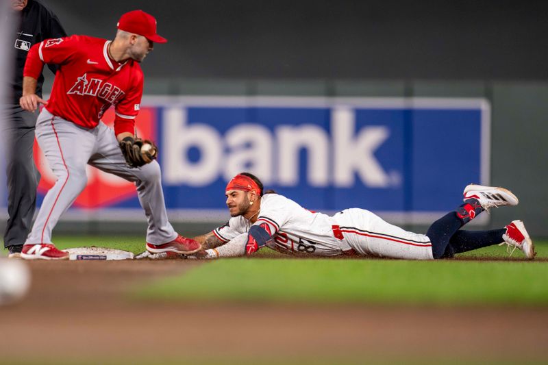 Sep 9, 2024; Minneapolis, Minnesota, USA; Minnesota Twins left fielder Austin Martin (82) slides into second base for a double before Los Angeles Angels second baseman Michael Stefanic (38) can make a tag in the fourth inning at Target Field. Mandatory Credit: Jesse Johnson-Imagn Images