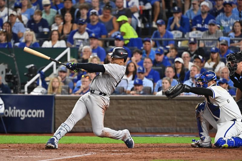 Oct 9, 2024; Kansas City, Missouri, USA; New York Yankees outfielder Juan Soto (22) hits a sacrifice fly ball in the fifth inning against the Kansas City Royals during game three of the NLDS for the 2024 MLB Playoffs at Kauffman Stadium. Mandatory Credit: Peter Aiken-Imagn Images