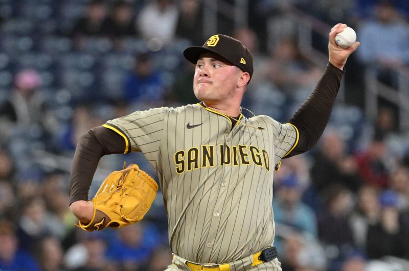 May 21, 2025; Toronto, Ontario, CAN;  San Diego Padres relief pitcher Adrian Morejon (50) delivers a pitch against the Toronto Blue Jays in the seventh inning at Rogers Centre. Mandatory Credit: Dan Hamilton-Imagn Images