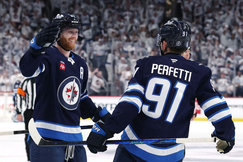 May 4, 2025; Winnipeg, Manitoba, CAN; Winnipeg Jets center Cole Perfetti (91) celebrates after his goal against the St. Louis Blues with left wing Kyle Connor (81) in the second period in game seven of the first round of the 2025 Stanley Cup Playoffs at Canada Life Centre. Mandatory Credit: James Carey Lauder-Imagn Images