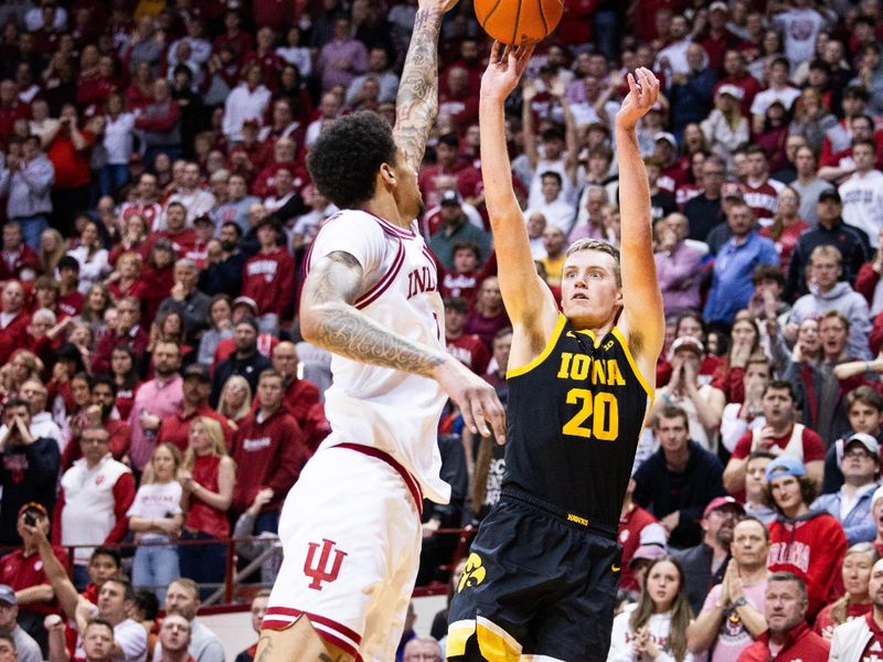 Jan 30, 2024; Bloomington, Indiana, USA; Iowa Hawkeyes forward Payton Sandfort (20) shoots the ball while Indiana Hoosiers center Kel'el Ware (1) defends in the second half at Simon Skjodt Assembly Hall. Mandatory Credit: Trevor Ruszkowski-USA TODAY Sports