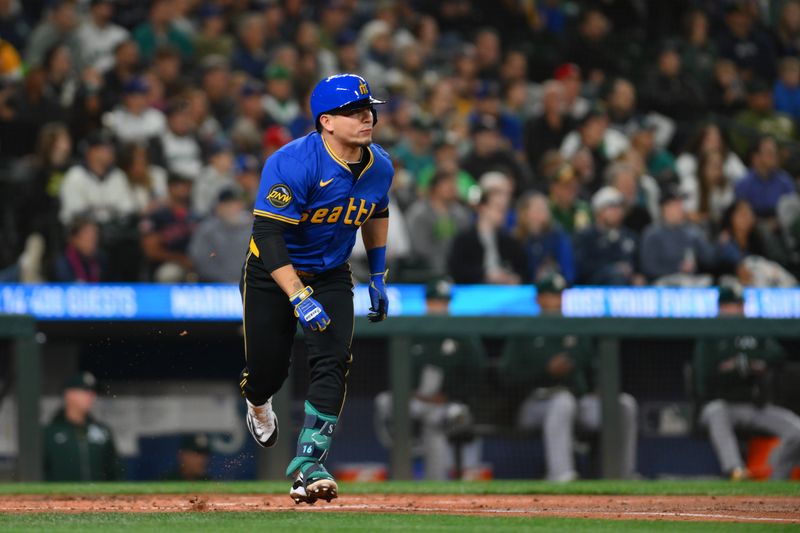 Sep 27, 2024; Seattle, Washington, USA; Seattle Mariners third baseman Luis Urias (23) runs towards first base after hitting a double against the Oakland Athletics during the second inning at T-Mobile Park. Mandatory Credit: Steven Bisig-Imagn Images