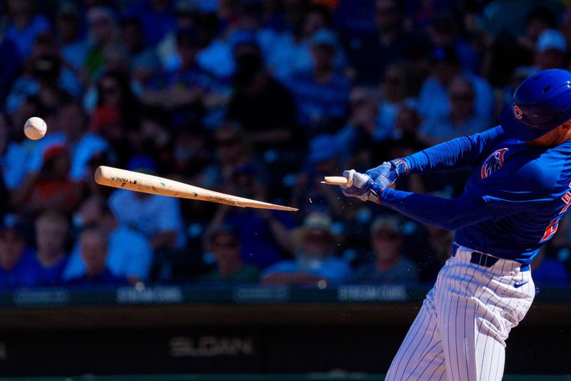 Mar 22, 2024; Mesa, Arizona, USA; Chicago Cubs outfielder Cody Bellinger (24) reacts as his bat breaks for a single in the sixth inning during a spring training game against the San Francisco Giants at Sloan Park. Mandatory Credit: Allan Henry-USA TODAY Sports