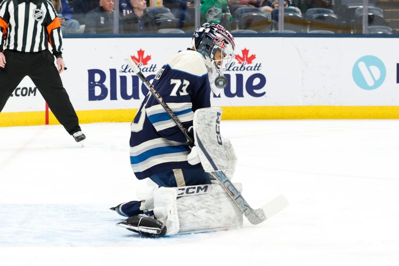 Mar 17, 2026; Columbus, Ohio, USA; Columbus Blue Jackets goalie Jet Greaves (73) takes a shot off his shoulder for a save against the Carolina Hurricanes during the first period at Nationwide Arena. Mandatory Credit: Russell LaBounty-Imagn Images