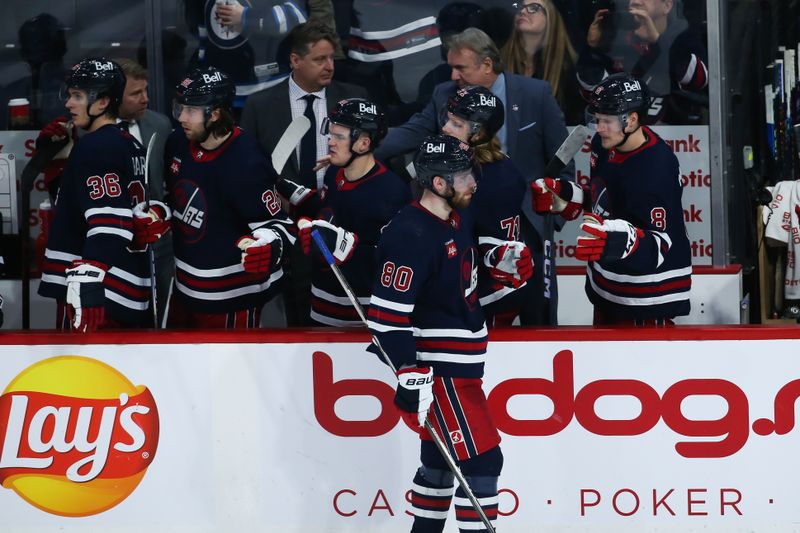 Jan 26, 2023; Winnipeg, Manitoba, CAN;  Winnipeg Jets forward Pierre-Luc Dubois (80) is congratulated by his team mates on his goal against the Buffalo Sabres during the third period at Canada Life Centre. Mandatory Credit: Terrence Lee-USA TODAY Sports