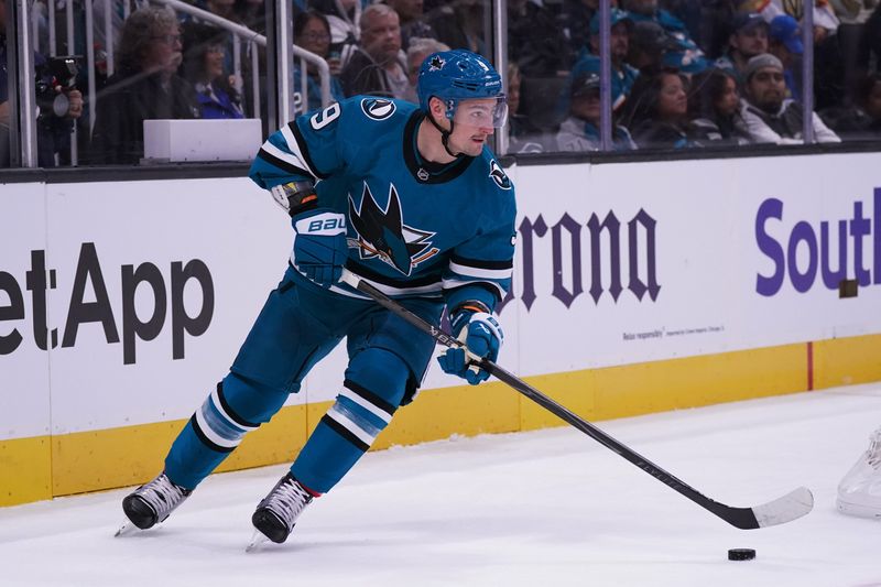 Nov 7, 2025; San Jose, California, USA; San Jose Sharks defenseman Dmitry Orlov (9) plays the puck against the Winnipeg Jets during the first period at SAP Center at San Jose. Mandatory Credit: David Gonzales-Imagn Images