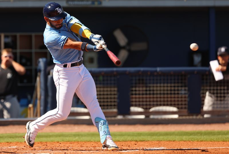 Feb 27, 2024; Port Charlotte, Florida, USA;  Tampa Bay Rays second baseman Jose Caballero (7) doubles during the fifth inning against the New York Yankees at Charlotte Sports Park. Mandatory Credit: Kim Klement Neitzel-USA TODAY Sports