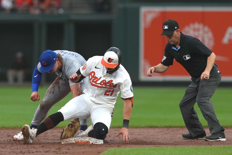 Jul 10, 2024; Baltimore, Maryland, USA; Baltimore Orioles outfielder Austin Hays (21) slides in safely with a double during the second inning against the Chicago Cubs at Oriole Park at Camden Yards. Mandatory Credit: Mitch Stringer-USA TODAY Sports