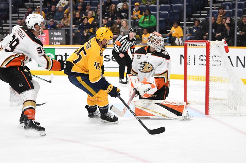 Jan 9, 2024; Nashville, Tennessee, USA; Nashville Predators defenseman Alexandre Carrier (45) scores against Anaheim Ducks goaltender Lukas Dostal (1) during the third period at Bridgestone Arena. Mandatory Credit: Christopher Hanewinckel-USA TODAY Sports