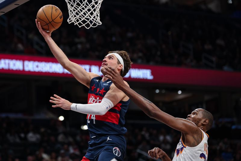 WASHINGTON, DC - JANUARY 16: Corey Kispert #24 of the Washington Wizards shoots a lay up against Kevin Durant #35 of the Phoenix Suns during the second half at Capital One Arena on January 16, 2025 in Washington, DC. NOTE TO USER: User expressly acknowledges and agrees that, by downloading and or using this photograph, User is consenting to the terms and conditions of the Getty Images License Agreement. (Photo by Scott Taetsch/Getty Images)