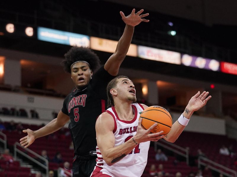 Feb 14, 2024; Fresno, California, USA; Fresno State Bulldogs guard Isaiah Pope (21) misses a shot under the hoop in front of UNLV Rebels forward Rob Whaley Jr. (5) in the second half at the Save Mart Center. Mandatory Credit: Cary Edmondson-USA TODAY Sports