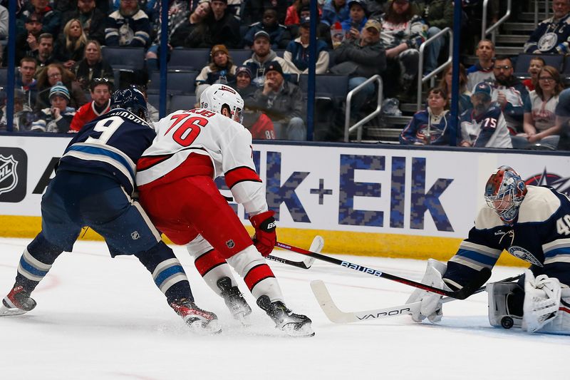 Feb 29, 2024; Columbus, Ohio, USA; Carolina Hurricanes defenseman Brady Skjei (76) slides the puck through the pads of Columbus Blue Jackets goalie Daniil Tarasov (40) for a gaol during the second period at Nationwide Arena. Mandatory Credit: Russell LaBounty-USA TODAY Sports