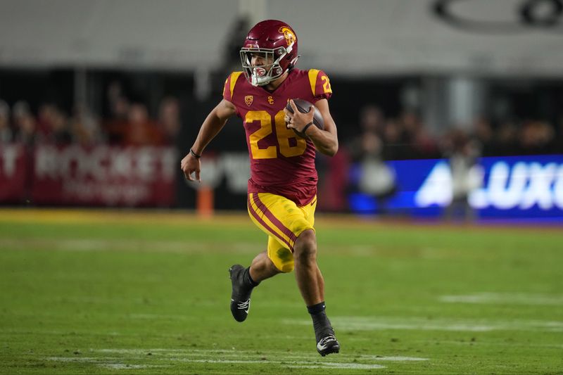 Nov 5, 2022; Los Angeles, California, USA; Southern California Trojans running back Travis Dye (26) carries the ball against the California Golden Bears in the second half at United Airlines Field at Los Angeles Memorial Coliseum. Mandatory Credit: Kirby Lee-USA TODAY Sports