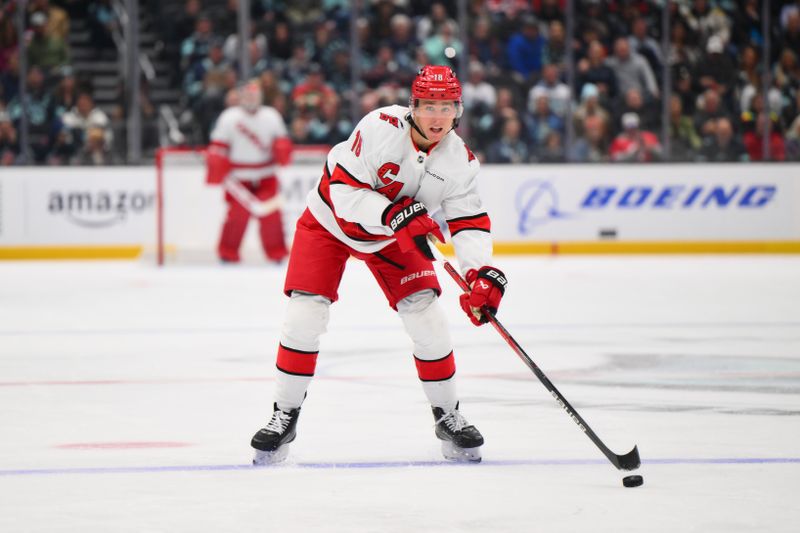 Oct 26, 2024; Seattle, Washington, USA; Carolina Hurricanes center Jack Drury (18) advances the puck against the Seattle Kraken during the second period at Climate Pledge Arena. Mandatory Credit: Steven Bisig-Imagn Images