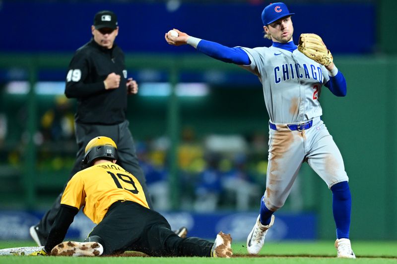 May 10, 2024; Pittsburgh, Pennsylvania, USA; Chicago Cubs shortstop Nico Hoerner (2) forces out Pittsburgh Pirates second baseman Jared Triolo (19) and turns a double play in the fourth inning at PNC Park. Mandatory Credit: David Dermer-USA TODAY Sports