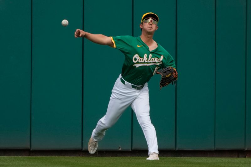 Mar 23, 2024; Mesa, Arizona, USA; Oakland Athletics left fielder Hoy Park (11) throws the ball in against the Los Angeles Angels in the first inning at Hohokam Stadium. Mandatory Credit: Rick Scuteri-USA TODAY Sports