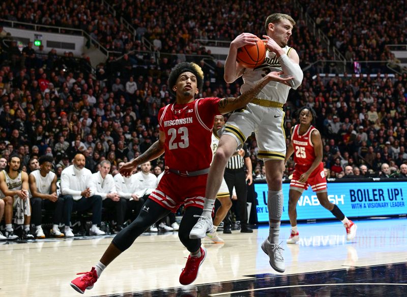 Mar 10, 2024; West Lafayette, Indiana, USA; Purdue Boilermakers guard Braden Smith (3) grabs a rebound in front of Wisconsin Badgers guard Chucky Hepburn (23) during the first half at Mackey Arena. Mandatory Credit: Marc Lebryk-USA TODAY Sports