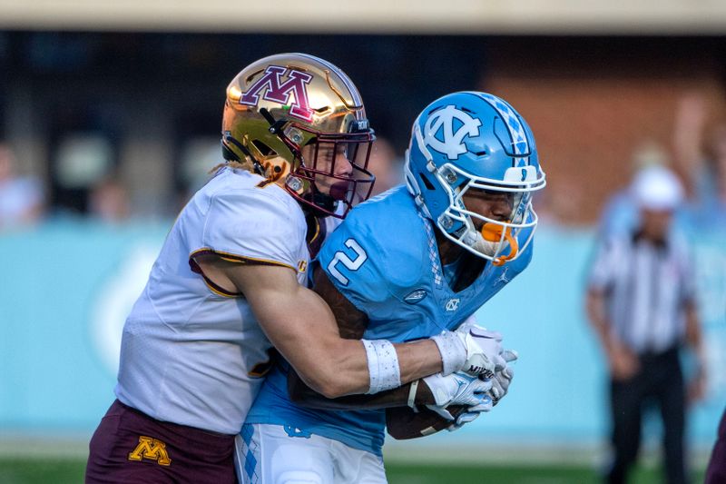 Sep 16, 2023; Chapel Hill, North Carolina, USA; North Carolina Tar Heels wide receiver Gavin Blackwell (2) catches the ball as Minnesota Golden Gophers defensive back Aidan Gousby (7) defends in the third quarter at Kenan Memorial Stadium. Mandatory Credit: Bob Donnan-USA TODAY Sports