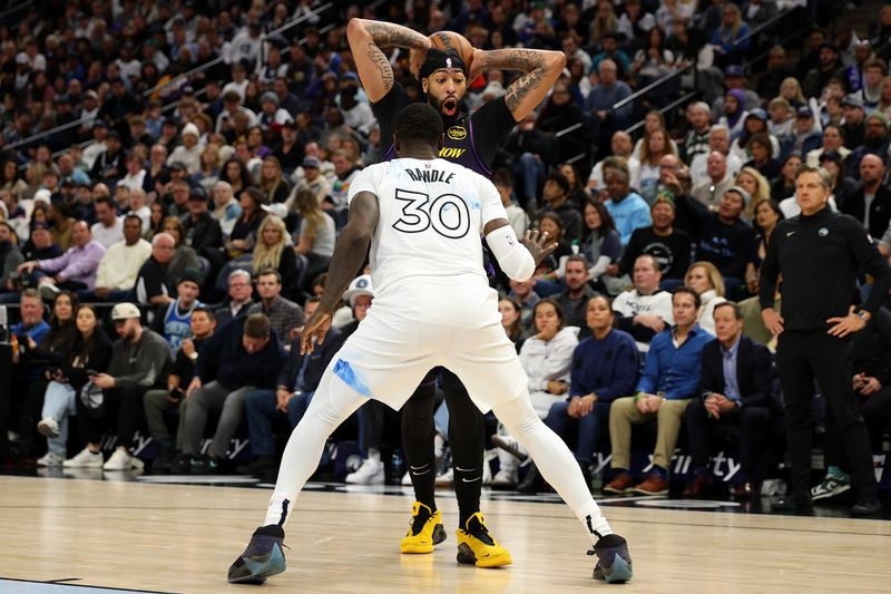 MINNEAPOLIS, MINNESOTA - DECEMBER 02: Anthony Davis #3 of the Los Angeles Lakers handles the ball against Julius Randle #30 of the Minnesota Timberwolves in the third quarter at Target Center on December 02, 2024 in Minneapolis, Minnesota. The Timberwolves defeated the Lakers 109-80. NOTE TO USER: User expressly acknowledges and agrees that, by downloading and or using this photograph, User is consenting to the terms and conditions of the Getty Images License Agreement. (Photo by David Berding/Getty Images)