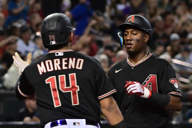 Sep 19, 2023; Phoenix, Arizona, USA; Arizona Diamondbacks shortstop Geraldo Perdomo (2) and catcher Gabriel Moreno (14) celebrate after scoring in the second inning against the San Francisco Giants at Chase Field. Mandatory Credit: Matt Kartozian-USA TODAY Sports