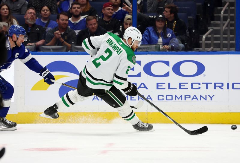 Dec 4, 2023; Tampa, Florida, USA; Dallas Stars defenseman Jani Hakanpaa (2) skates wit the puck as Tampa Bay Lightning center Steven Stamkos (91) defends during the first period at Amalie Arena. Mandatory Credit: Kim Klement Neitzel-USA TODAY Sports