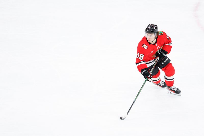 Jan 15, 2026; Chicago, Illinois, USA; Chicago Blackhawks center Connor Bedard (98) controls the puck against the Calgary Flames during the third period at United Center. Mandatory Credit: Kamil Krzaczynski-Imagn Images