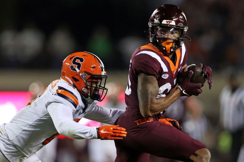 Oct 26, 2023; Blacksburg, Virginia, USA; Virginia Tech Hokies wide receiver Jaylin Lane (83) catches a pass against Syracuse Orange defensive back Jason Simmons Jr. (6) during the second quarter at Lane Stadium. Mandatory Credit: Peter Casey-USA TODAY Sports