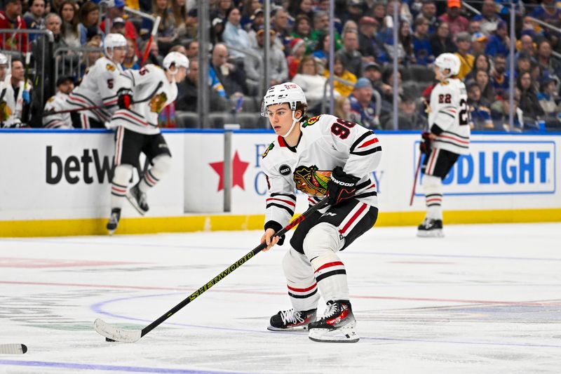 Dec 23, 2023; St. Louis, Missouri, USA;  Chicago Blackhawks center Connor Bedard (98) controls the puck against the St. Louis Blues during the third period at Enterprise Center. Mandatory Credit: Jeff Curry-USA TODAY Sports