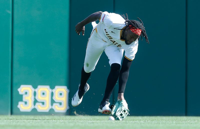 Sep 14, 2024; Pittsburgh, Pennsylvania, USA;  Pittsburgh Pirates center fielder Oneil Cruz (15) misplays a ball hit by Kansas City Royals shortstop Bobby Witt Jr. (not pictured) into a two base error during the seventh inning at PNC Park. Mandatory Credit: Charles LeClaire-Imagn Images