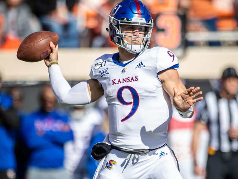 Nov 16, 2019; Stillwater, OK, USA; Kansas Jayhawks quarterback Carter Stanley (9) looks to pass against the Oklahoma State Cowboys during the first quarter at Boone Pickens Stadium. Mandatory Credit: Rob Ferguson-USA TODAY Sports