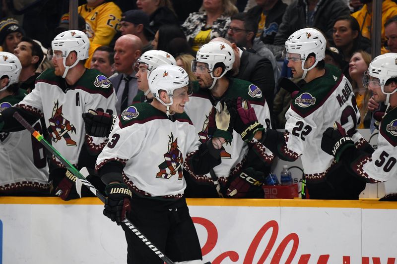 Feb 10, 2024; Nashville, Tennessee, USA; Arizona Coyotes defenseman Travis Dermott (33) is congratulated by teammates after a goal during the first period against the Nashville Predators at Bridgestone Arena. Mandatory Credit: Christopher Hanewinckel-USA TODAY Sports