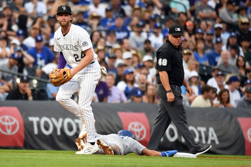 Jun 25, 2025; Denver, Colorado, USA; Los Angeles Dodgers second base Tommy Edman (25) is tagged out at third base by Colorado Rockies third base Ryan McMahon (24) during the third inning at Coors Field. Mandatory Credit: Christopher Hanewinckel-Imagn Images