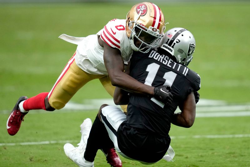 San Francisco 49ers cornerback Samuel Womack III (0) tackles Las Vegas Raiders wide receiver Phillip Dorsett (11) during the first half of an NFL preseason football game, Sunday, Aug. 13, 2023, in Las Vegas. (AP Photo/John Locher)