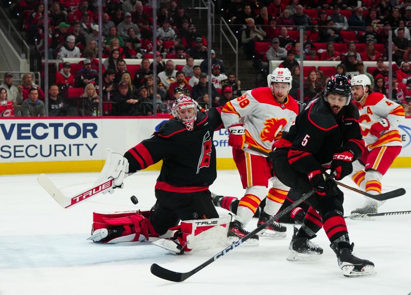 Mar 10, 2024; Raleigh, North Carolina, USA;  Carolina Hurricanes goaltender Frederik Andersen (31) reaches back to make a stick save against the Calgary Flames during the second period at PNC Arena. Mandatory Credit: James Guillory-USA TODAY Sports