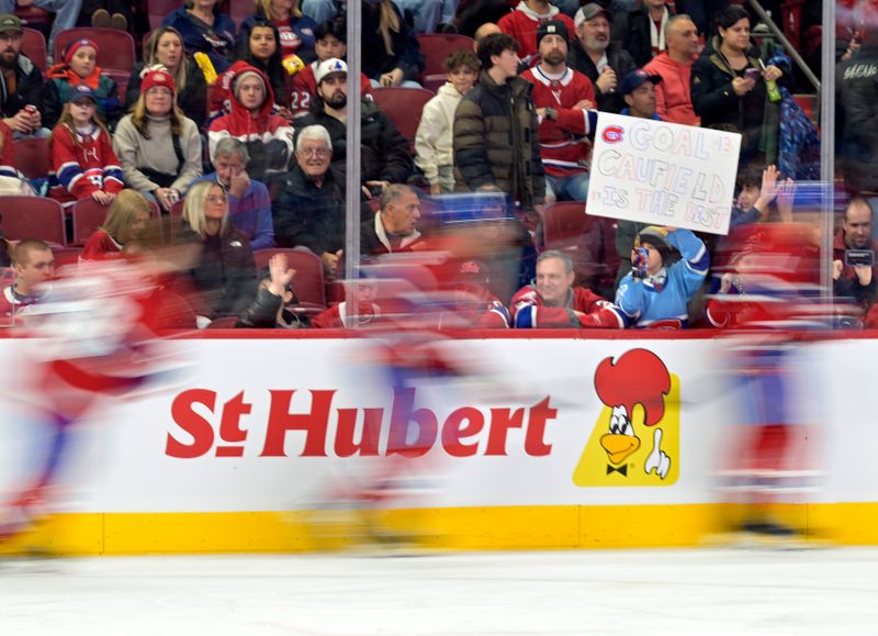 Jan 6, 2025; Montreal, Quebec, CAN; Young fan trying to get Montreal Canadiens players attention during the warmup period before the game against the Vancouver Canucks at the Bell Centre. Mandatory Credit: Eric Bolte-Imagn Images